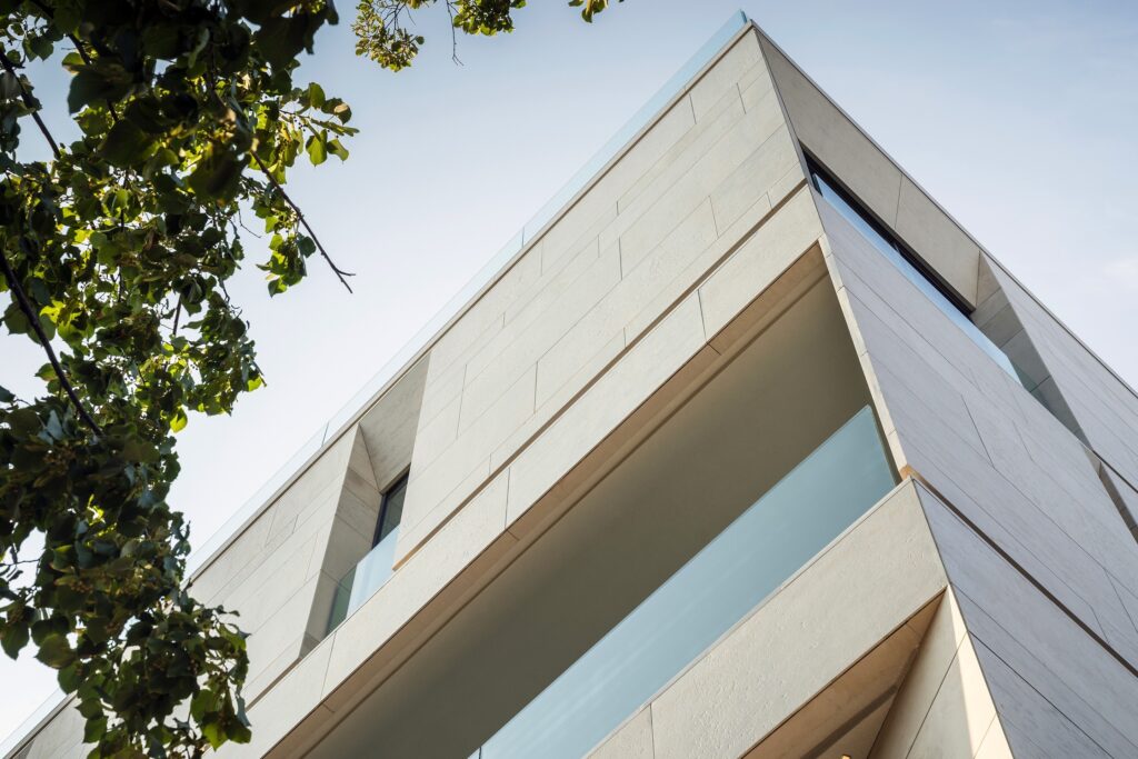 Deeply recessed windows sculpted into premium Vratza limestone