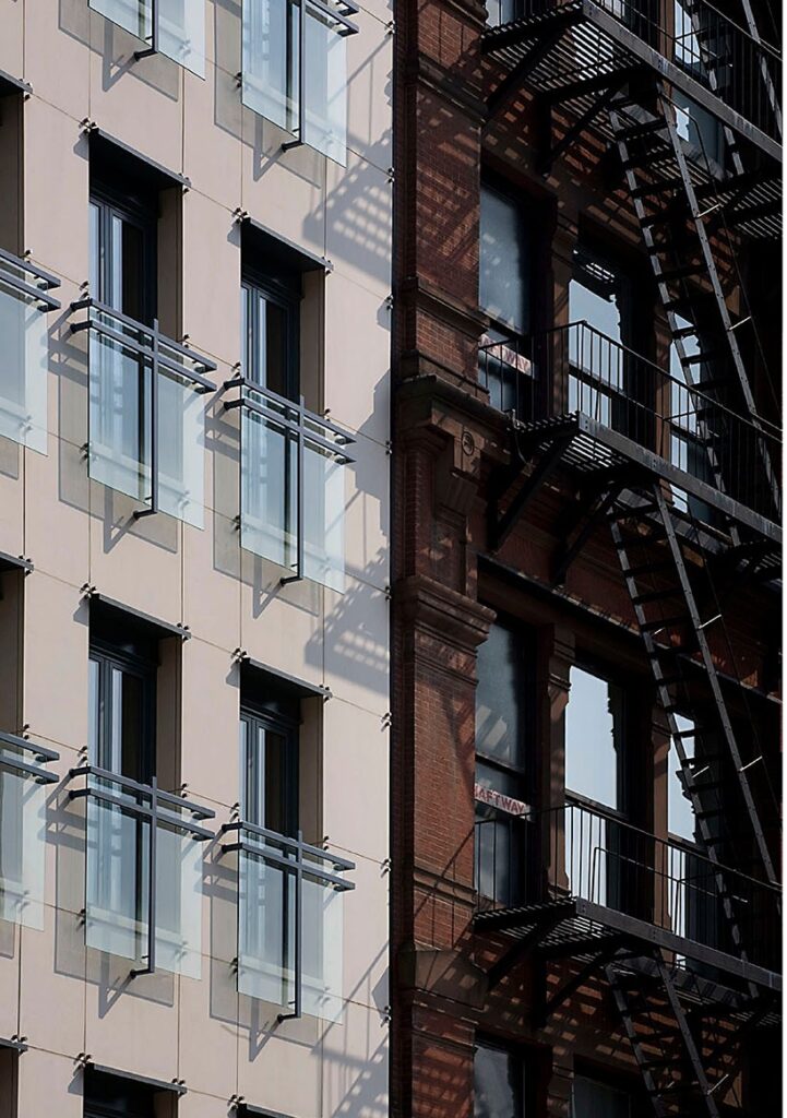 Classic modern facade combining dark steel and bright natural stone